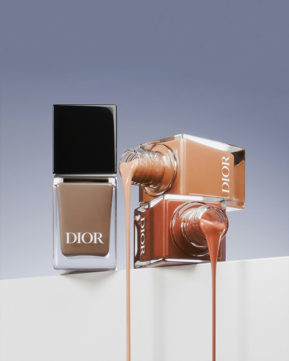 A bottle of dior's nail polish next to a bottle of dior