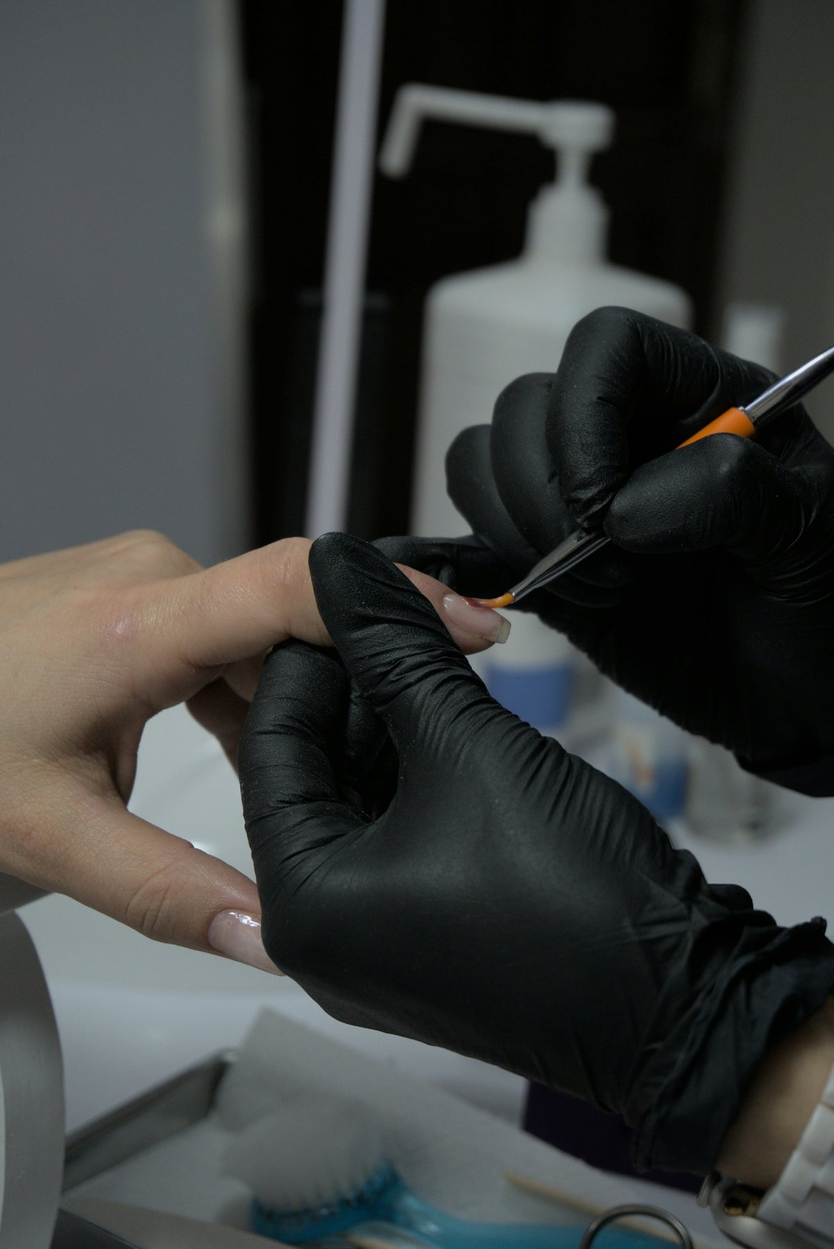 A person getting their nails done at a nail salon