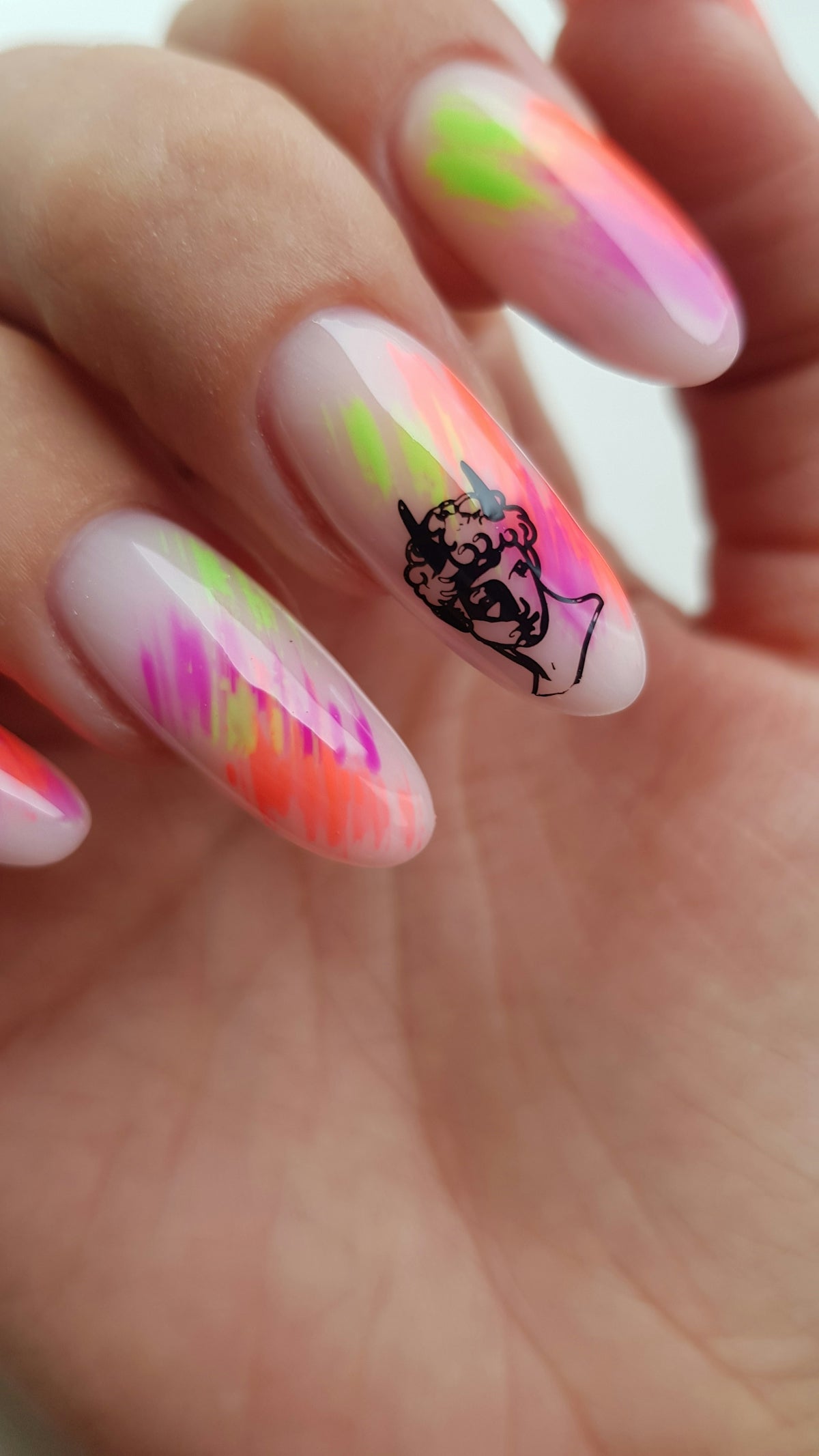 Nails with abstract neon paint and classical bust art.