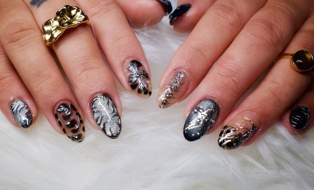 Woman's hands with decorative leopard print and leaf nails.